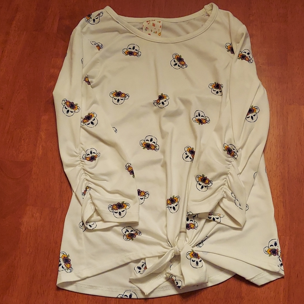 White shirt with koalas on the koalas are flowers